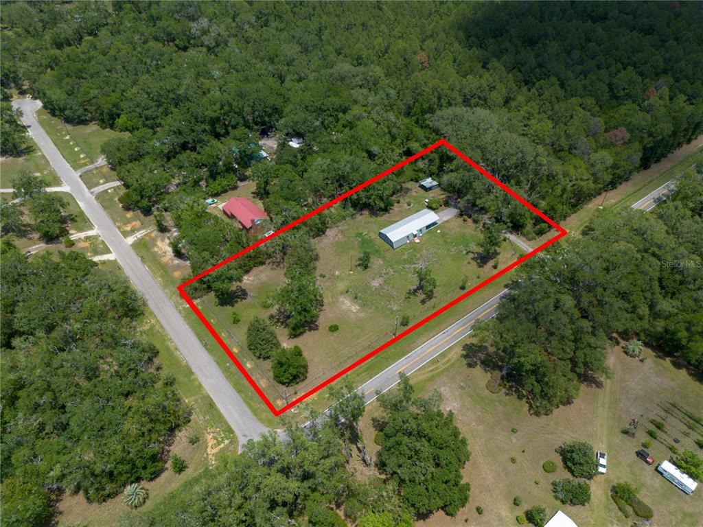 An aerial view shows a rectangular property with a house and shed among trees — 9419 NW 235TH TERRACE, ALACHUA, FL