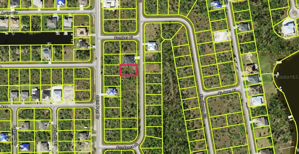 This is an aerial map showing a highlighted vacant residential lot in a suburban neighborhood — 9517 SUNDANCE STREET, PORT CHARLOTTE, FL