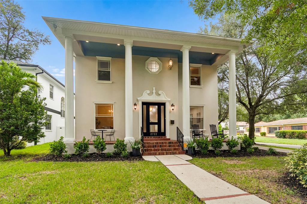 A two-story house with a columned front porch, a black front door, and brick steps — 2722 N MYRTLE AVENUE, TAMPA, FL