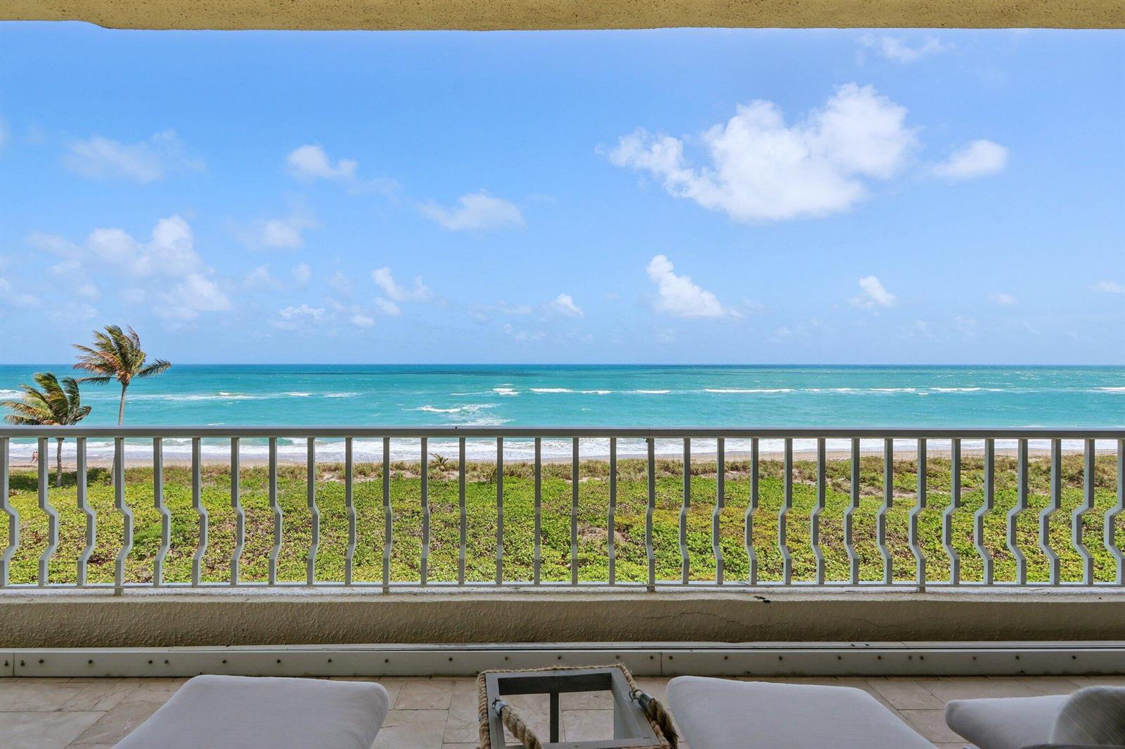A balcony with a metal railing overlooks a grassy dune and the ocean — 2920 SE Dune Drive # 420, Stuart FL 34996, STUART, FL