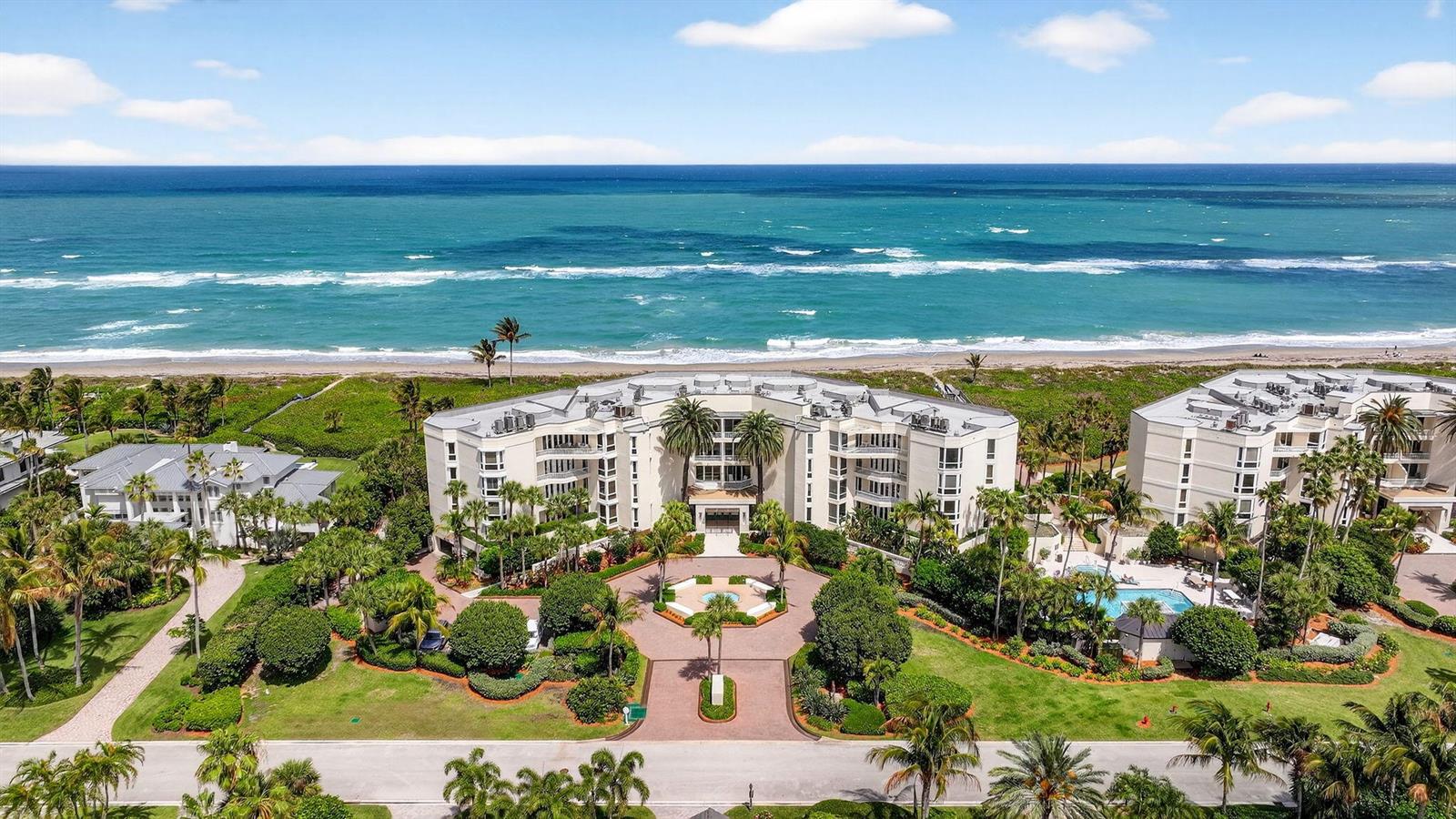 An aerial view of a beachfront apartment complex with a circular driveway and swimming pool — 2920 SE Dune Drive # 420, Stuart FL 34996, STUART, FL