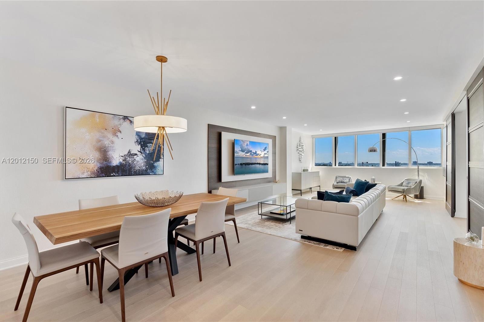 A modern open-concept living and dining room features light wood floors and floor-to-ceiling windows — 10275 Collins Ave # 1530, Bal Harbour FL 33154, BAL HARBOUR, FL