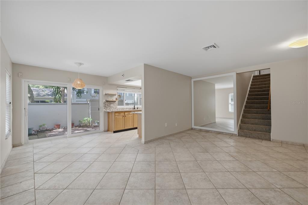 A kitchen features light wood cabinets, gray countertops, a tiled backsplash, and a skylight — 6214 DEWDROP WAY, TEMPLE TERRACE, FL