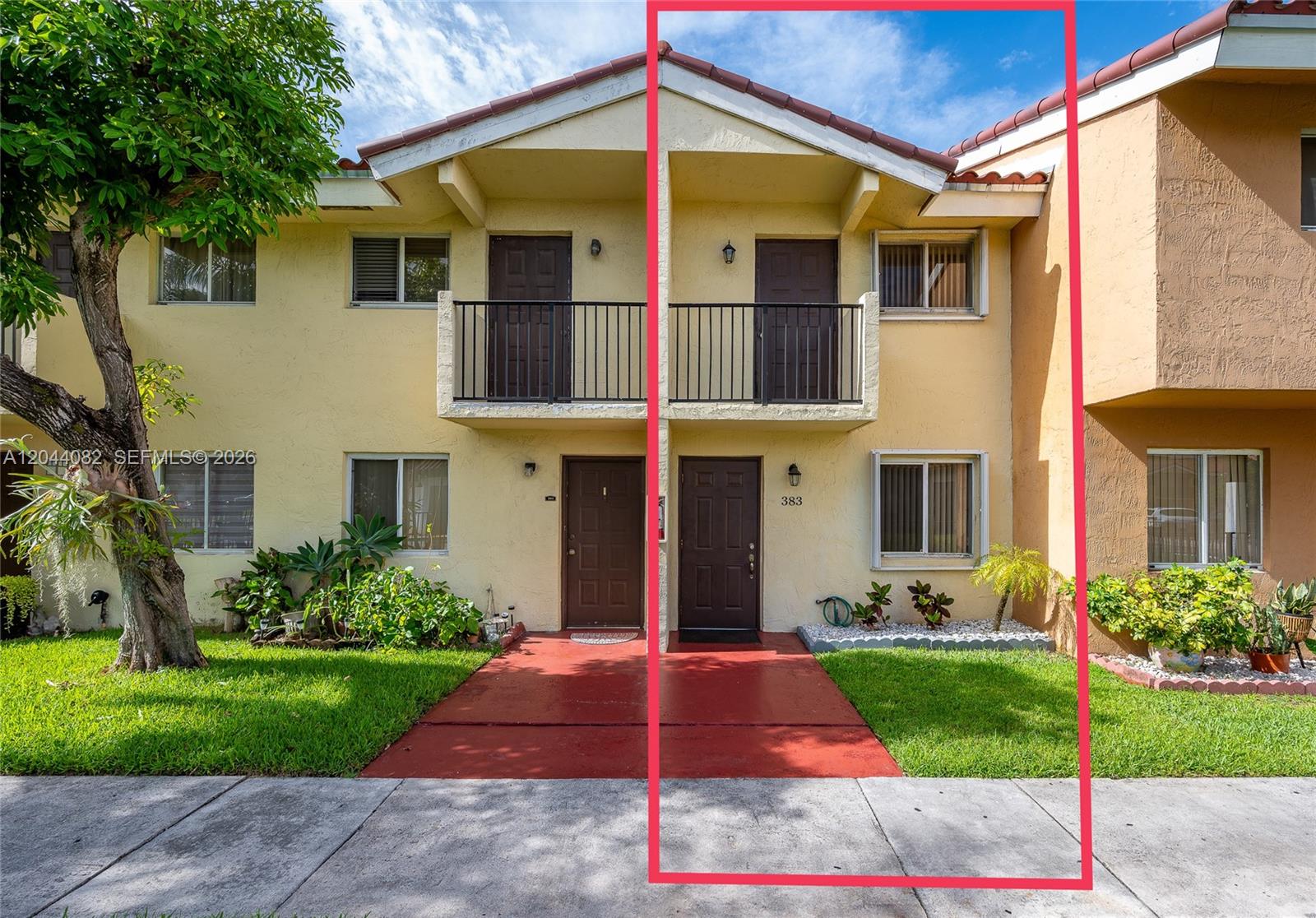 A two-story townhouse exterior with a red walkway, brown doors, and a small balcony — 550 NW 82nd Ct # 383, Miami FL 33126, MIAMI, FL