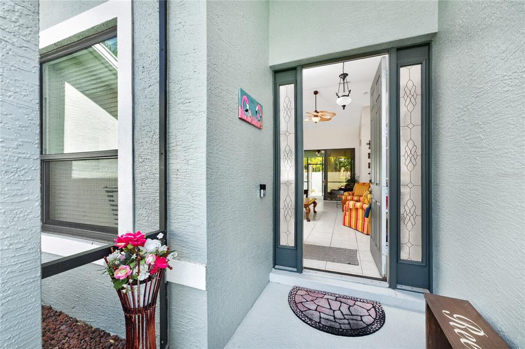 A view from a porch looking through an open front door into a living area — 24416 LAKEVIEW PLACE, PORT CHARLOTTE, FL