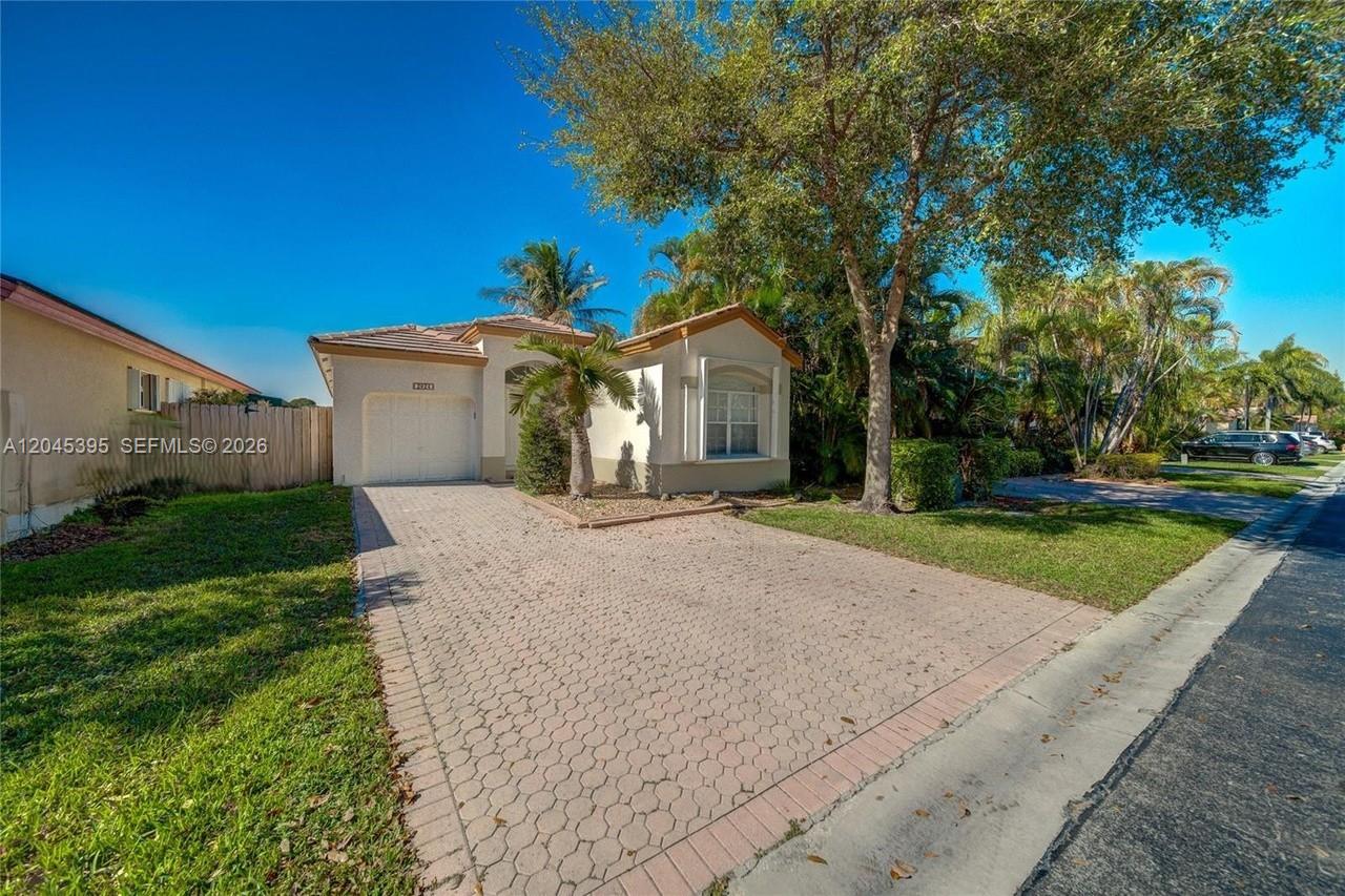 A single-story house with a paved driveway, a one-car garage, and mature landscaping — 2924 NW 99th Pl, Doral FL 33172, DORAL, FL