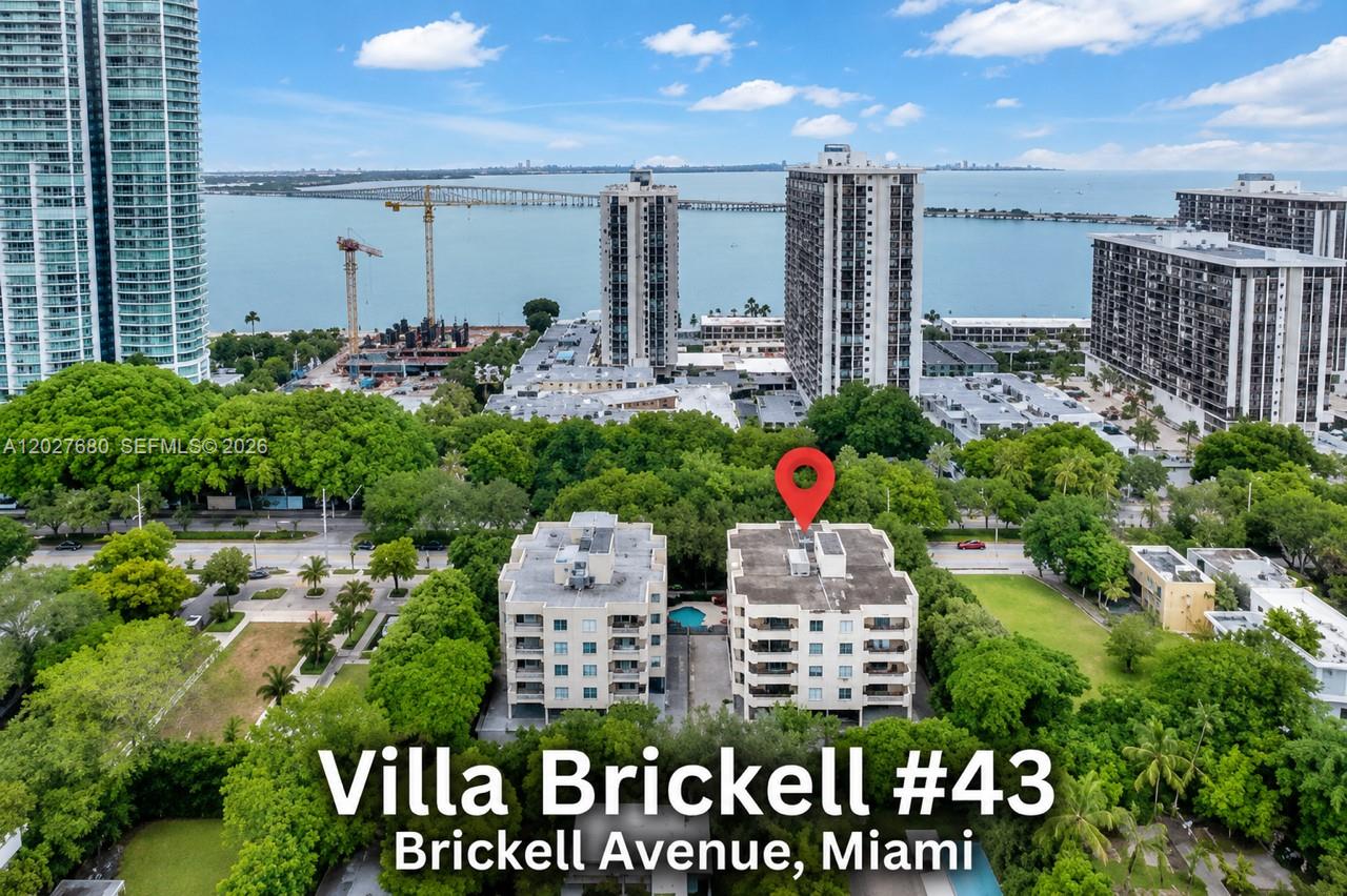 An aerial view shows two mid-rise apartment buildings surrounded by trees near the waterfront — 1834 Brickell Ave # 43, Miami FL 33129, MIAMI, FL