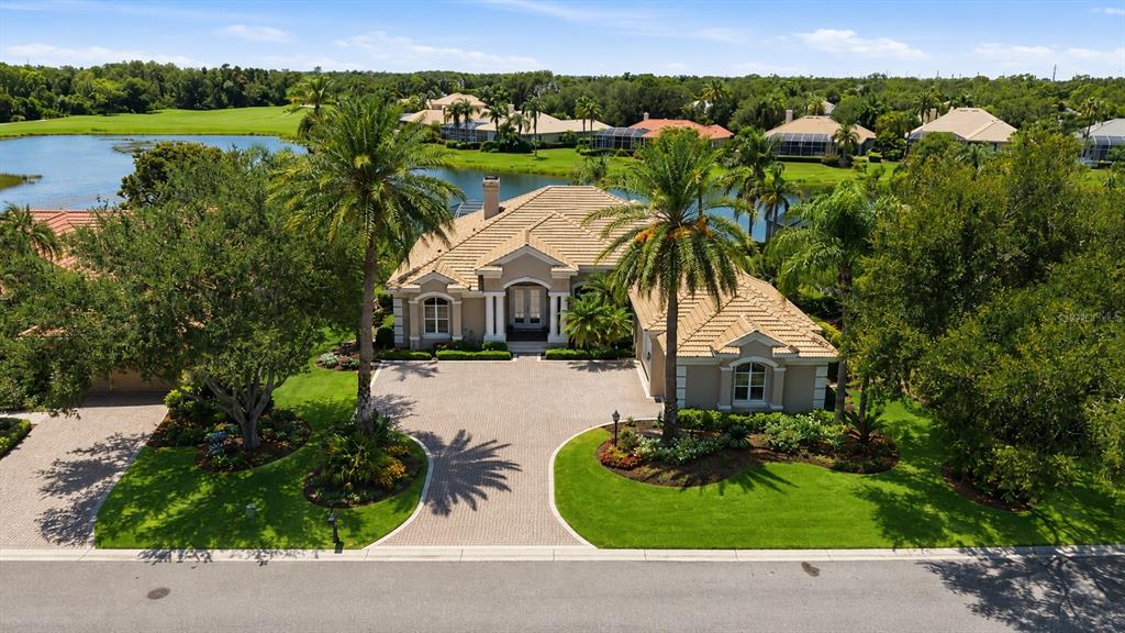 An aerial view of a tan house with a tile roof and a paved driveway — 7218 MARLOW PLACE, UNIVERSITY PARK, FL