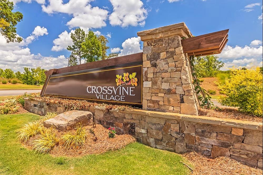 A stone monument sign for Crossvine Village stands in a landscaped area under a blue sky — 202 FRESHWATER COURT, LAGRANGE, GA
