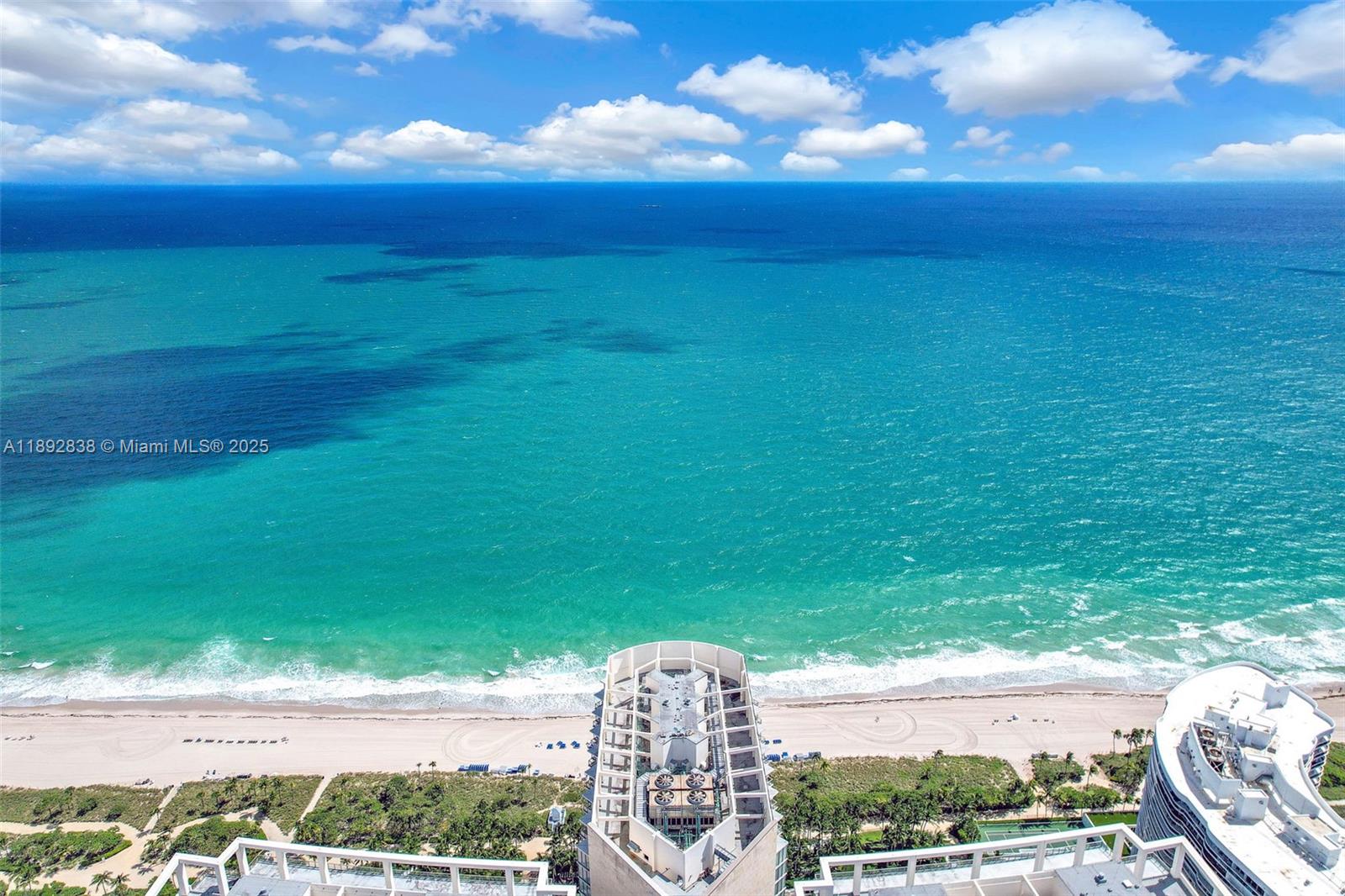 An aerial view shows a high-rise building rooftop overlooking a sandy beach and ocean — 9701 Collins Ave # 2104S, Bal Harbour FL 33154, BAL HARBOUR, FL