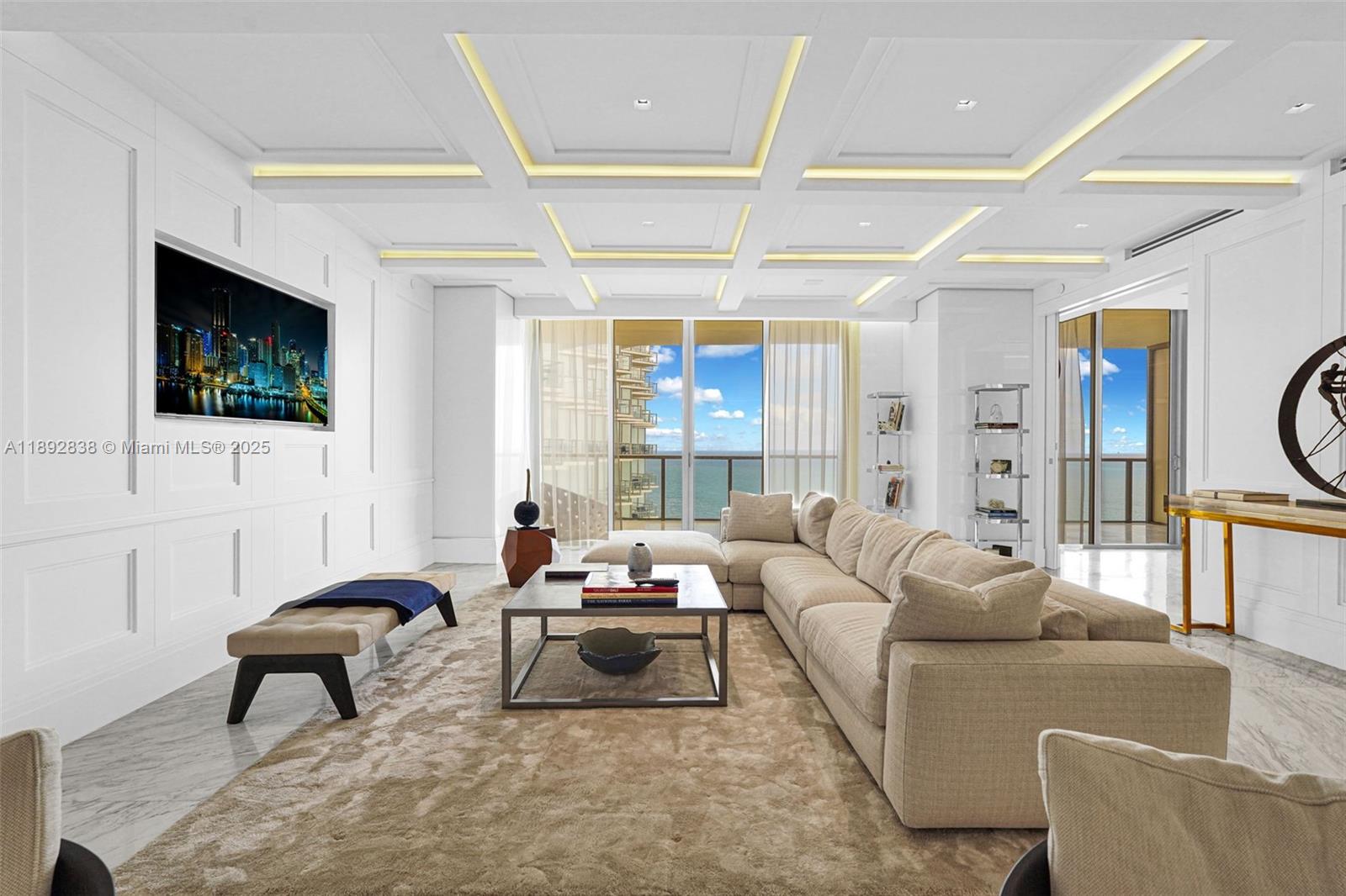A modern living room features white paneled walls, a coffered ceiling, and ocean views — 9701 Collins Ave # 2104S, Bal Harbour FL 33154, BAL HARBOUR, FL