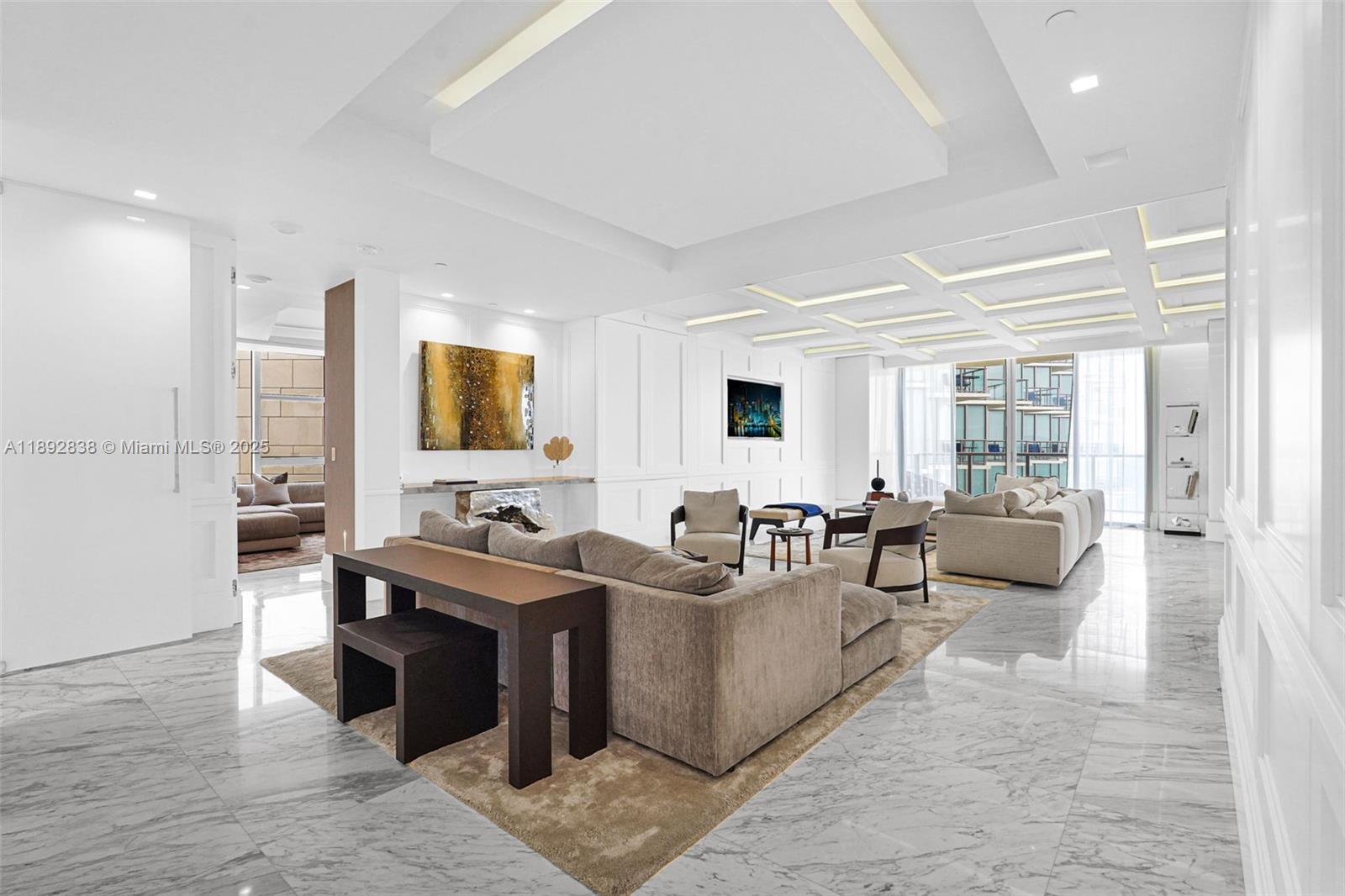 A spacious, modern living room features marble floors, recessed ceiling lighting, and neutral-toned furniture — 9701 Collins Ave # 2104S, Bal Harbour FL 33154, BAL HARBOUR, FL