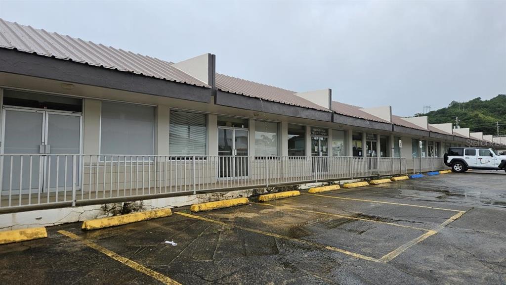 An exterior view of a single-story commercial strip mall with a parking lot in front — 2 CALLE 5, FAJARDO, PR