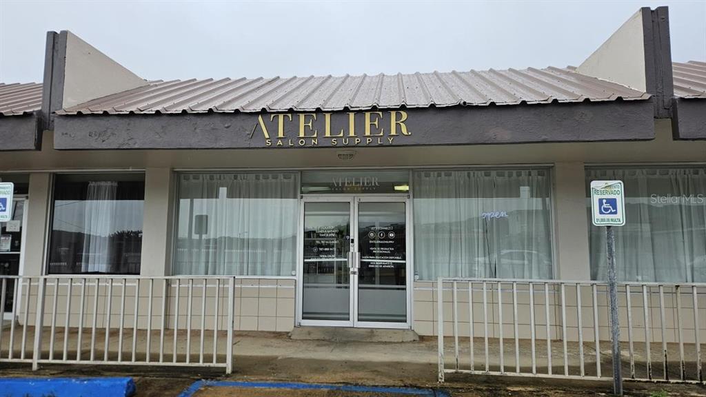 The exterior of a commercial storefront features a sign reading Atelier Salon Supply above glass doors — 2 CALLE 5, FAJARDO, PR