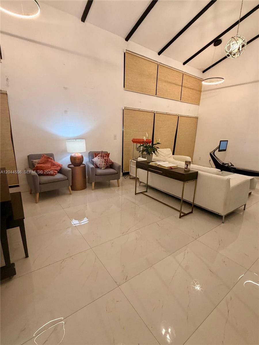 A living room features high ceilings, white tile floors, two gray armchairs, and a white sofa — 8646 SW 94th St, Miami FL 33156, MIAMI, FL