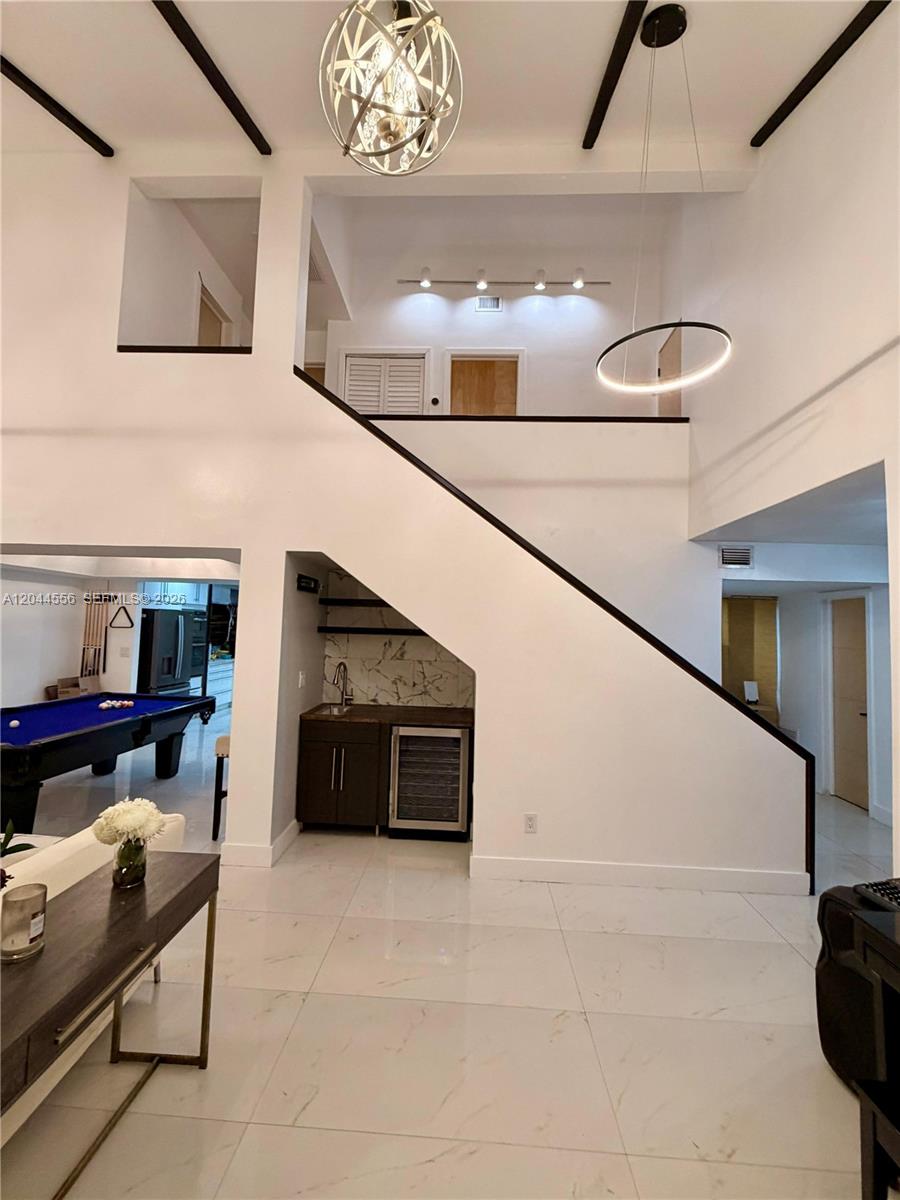 A two-story living area features a wet bar, a pool table, and modern lighting — 8646 SW 94th St, Miami FL 33156, MIAMI, FL