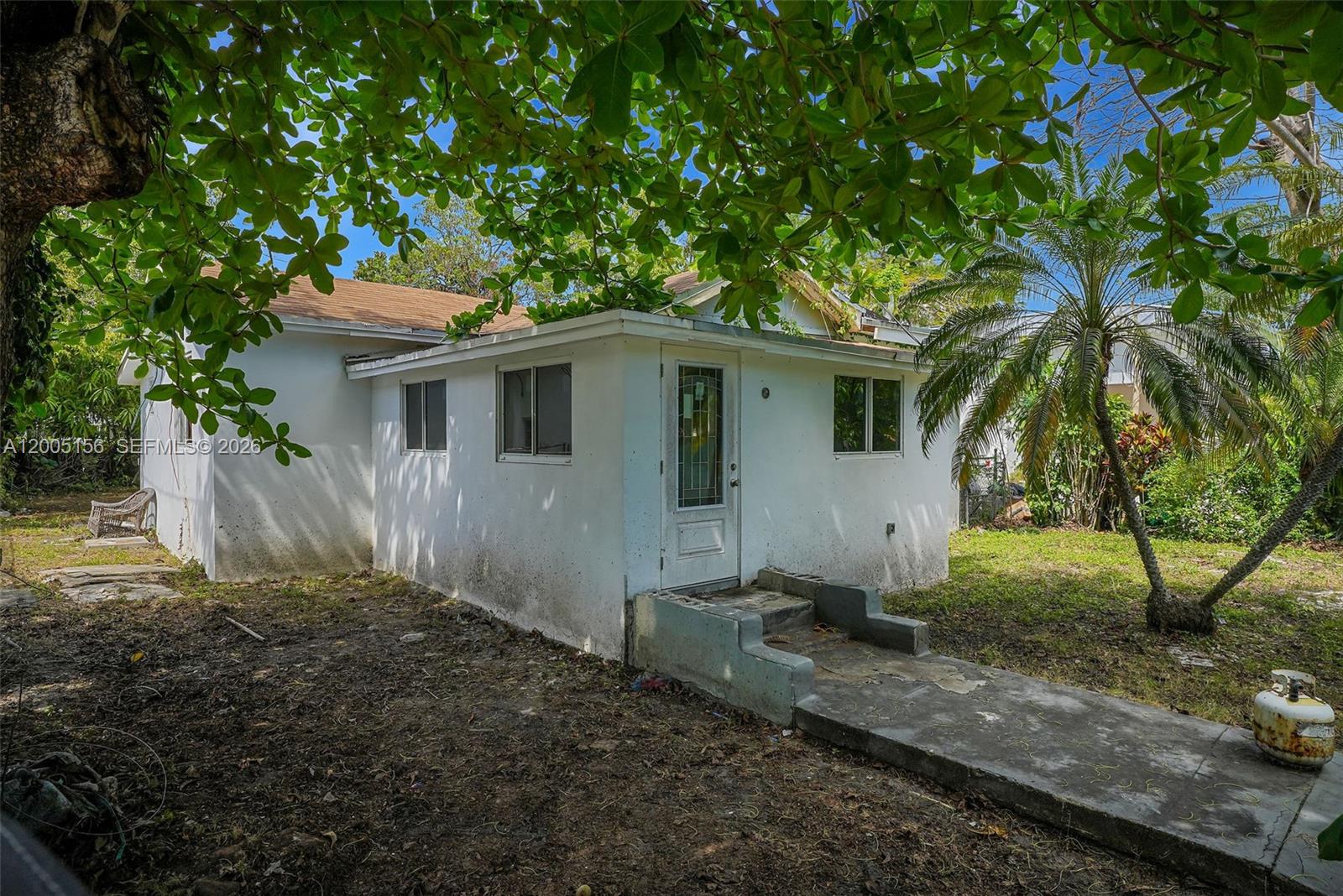 A white, single-story house with a flat-roofed addition and a concrete walkway — 3637 Frow Ave, Miami FL 33133, MIAMI, FL