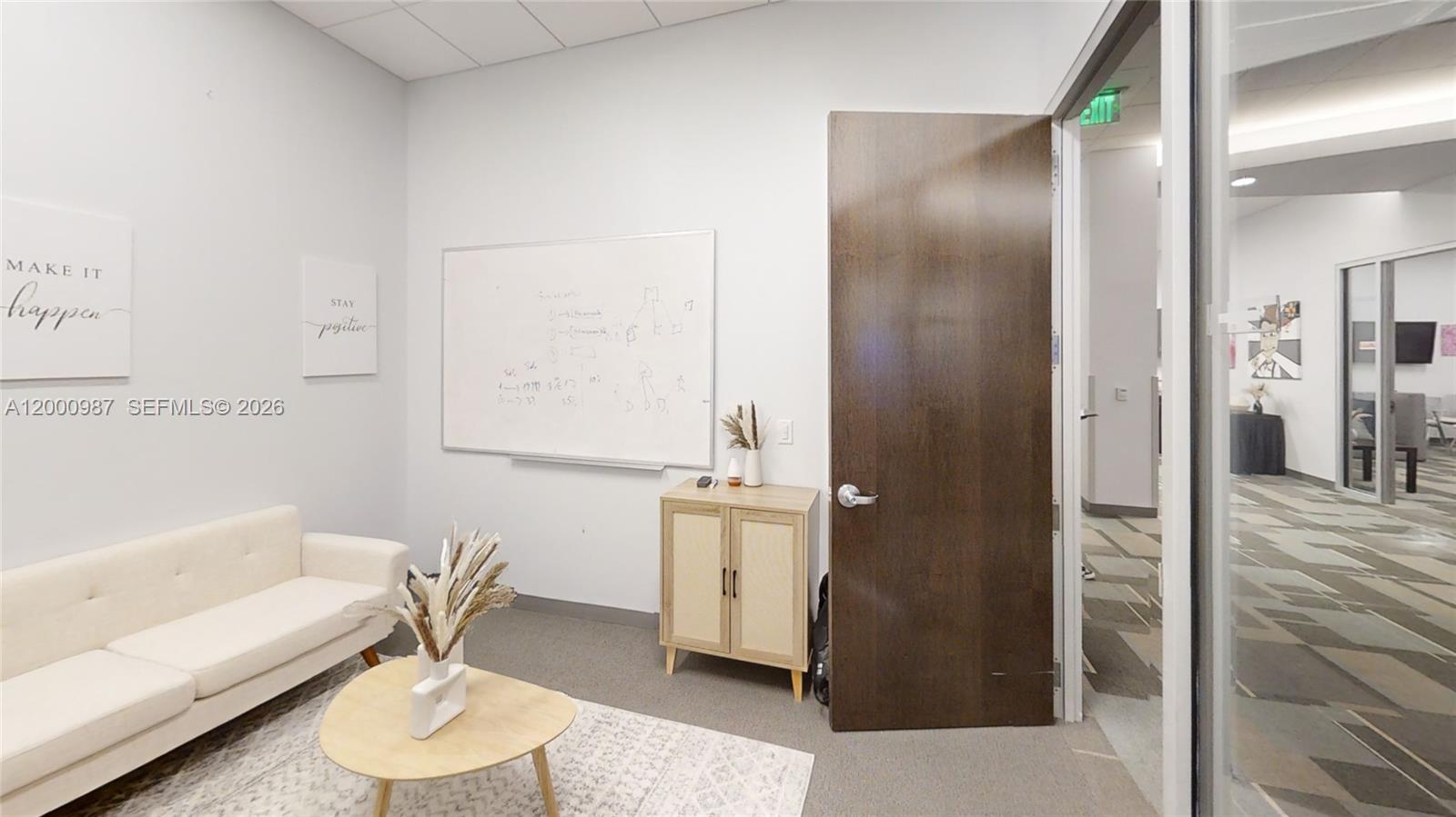 A small office features a white sofa, a whiteboard, and a wooden cabinet — 1501 Biscayne Blvd # D, FL 33132, FL