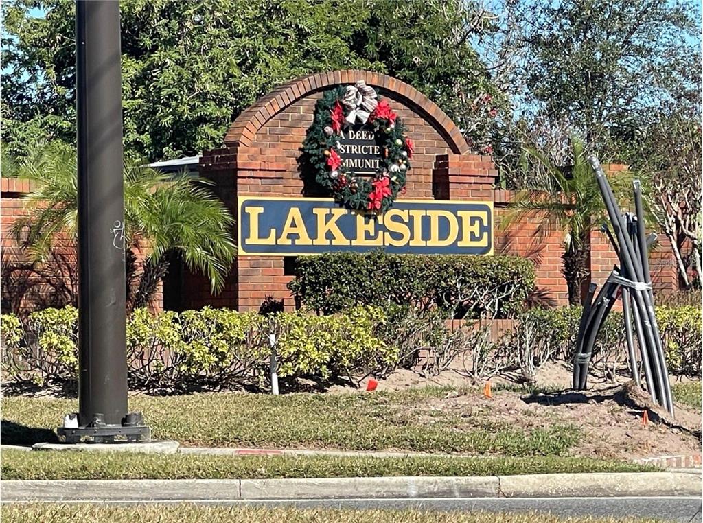 A brick entrance sign for a community named Lakeside features a holiday wreath — 2024 CYPRESS BAY BOULEVARD, KISSIMMEE, FL