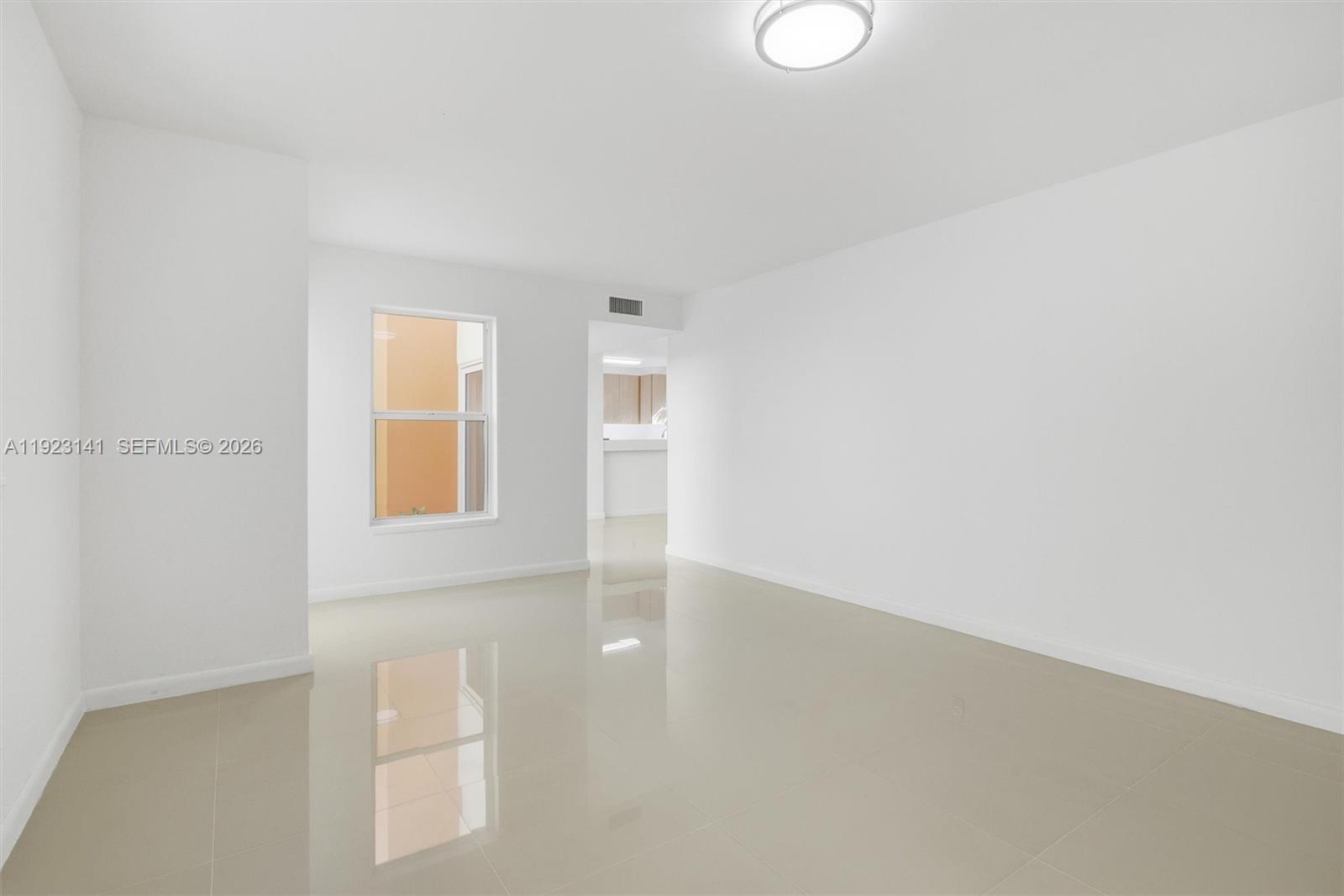 An empty room with white walls, a single window, and light-colored tile flooring — 1045 SW 25th Ave, Miami FL 33135, MIAMI, FL