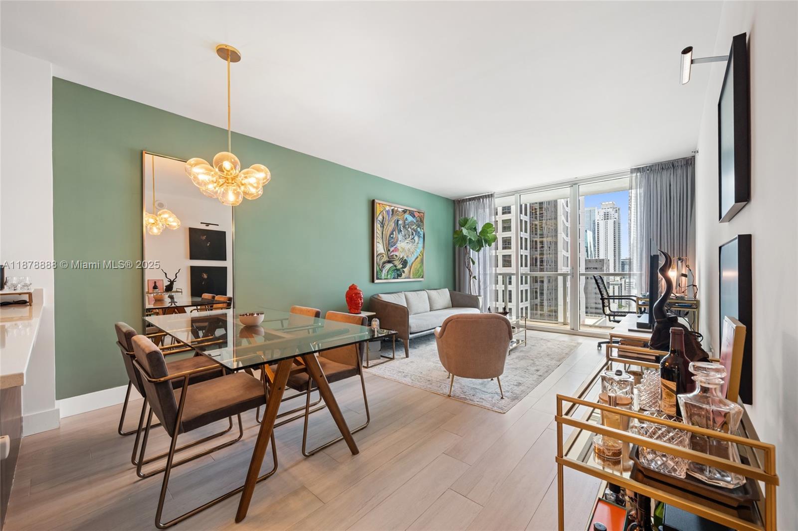 A modern kitchen island with stainless steel appliances sits in an open-concept living area — 55 SE 6th St # 1908, Miami FL 33131, MIAMI, FL