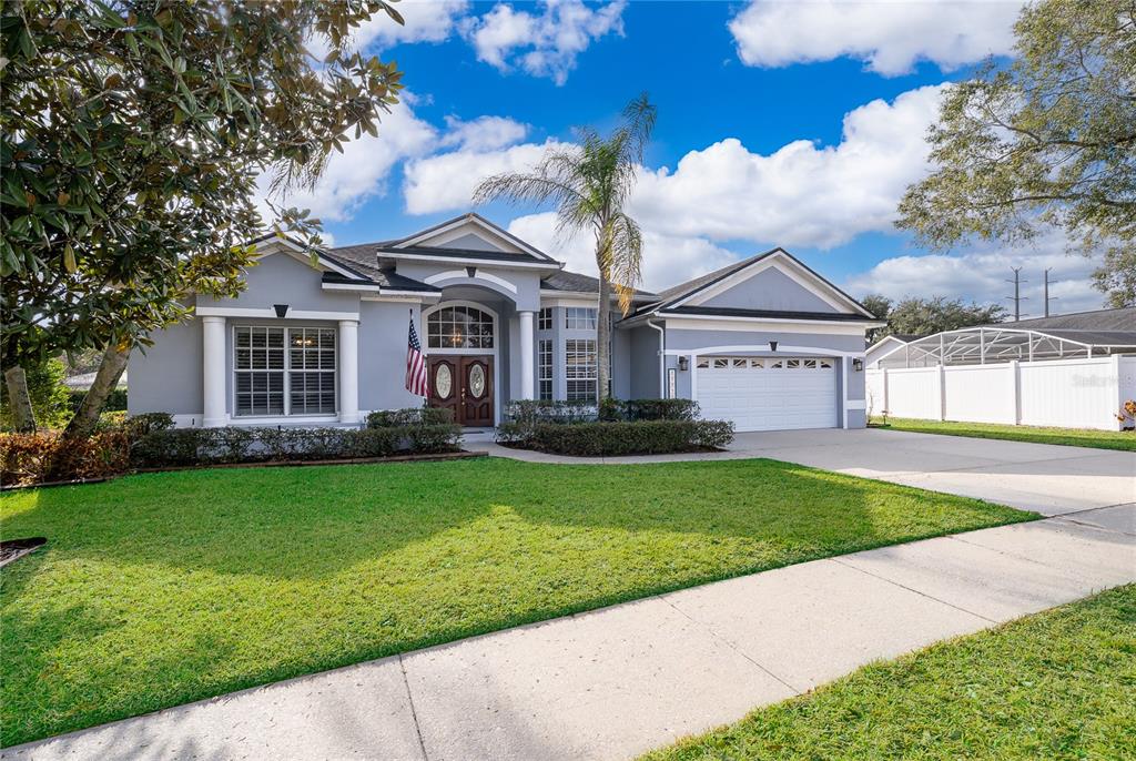 A single-story house with a gray exterior, a two-car garage, and a front lawn — 2277 NECTAR WAY, OVIEDO, FL