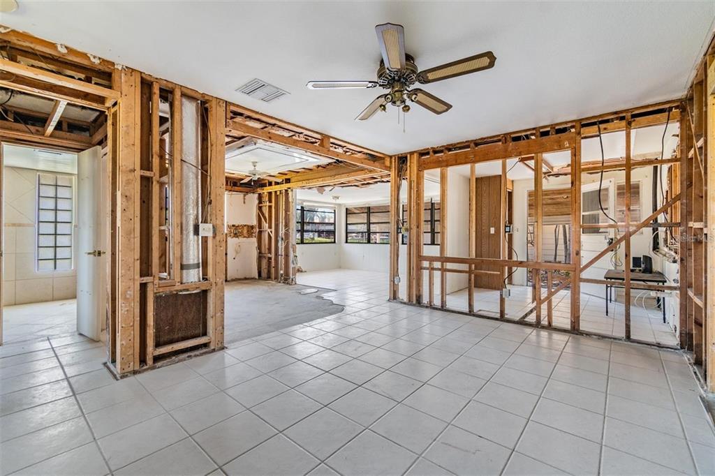 An interior view of a house under renovation with exposed wall studs and tiled flooring — 2620 TRENT ROAD, PALM HARBOR, FL