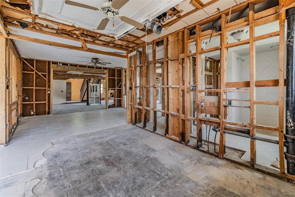 An interior view of a room under construction with exposed wooden wall studs and ceiling joists — 2620 TRENT ROAD, PALM HARBOR, FL