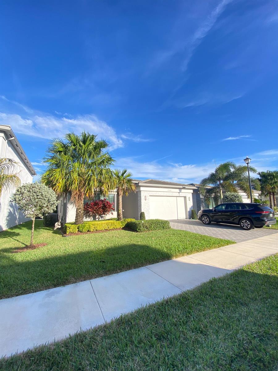 A single-story house with a paved driveway, a two-car garage, and palm trees — 17296 Sea Blossom Way, Boca Raton FL 33496, BOCA RATON, FL