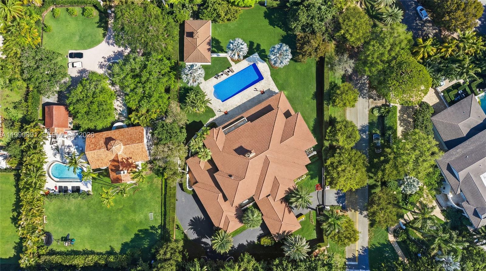 An aerial view shows a large house with a tiled roof, pool, and landscaped grounds — 7701 Old Cutler Rd, Coral Gables FL 33143, CORAL GABLES, FL