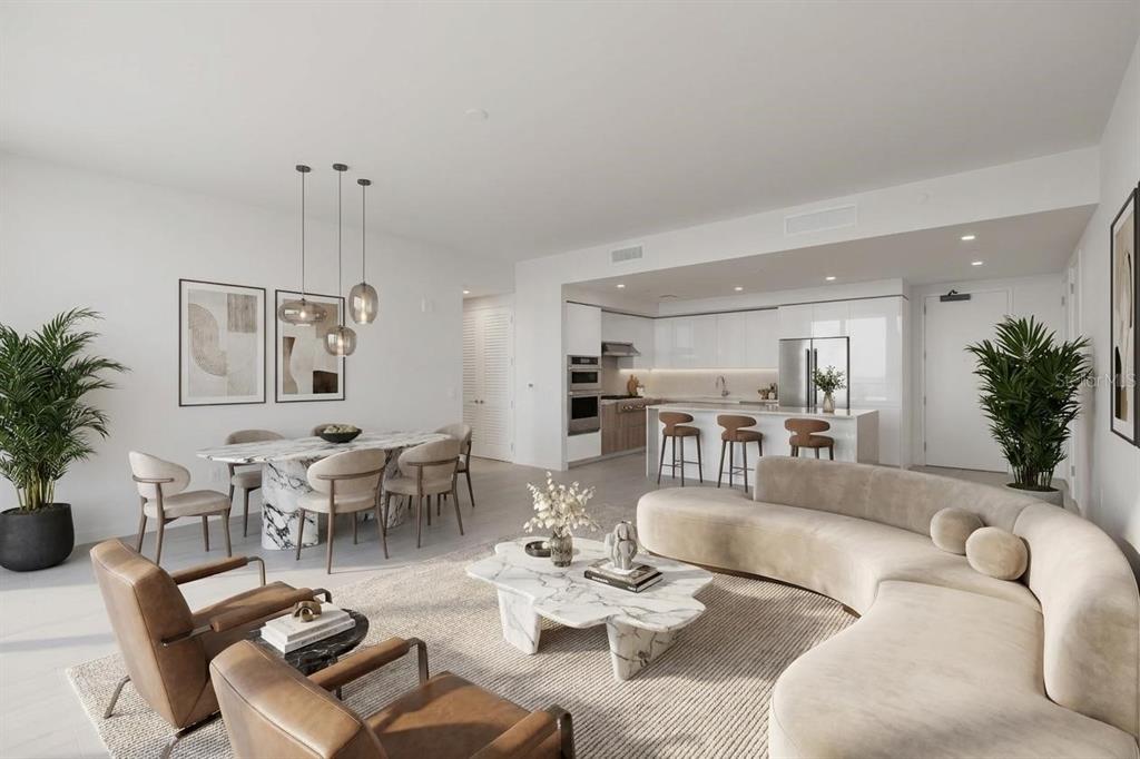 This open-concept living and dining area features a curved sofa, marble tables, and modern kitchen — 400 CENTRAL AVENUE UNIT 3606, ST PETERSBURG, FL