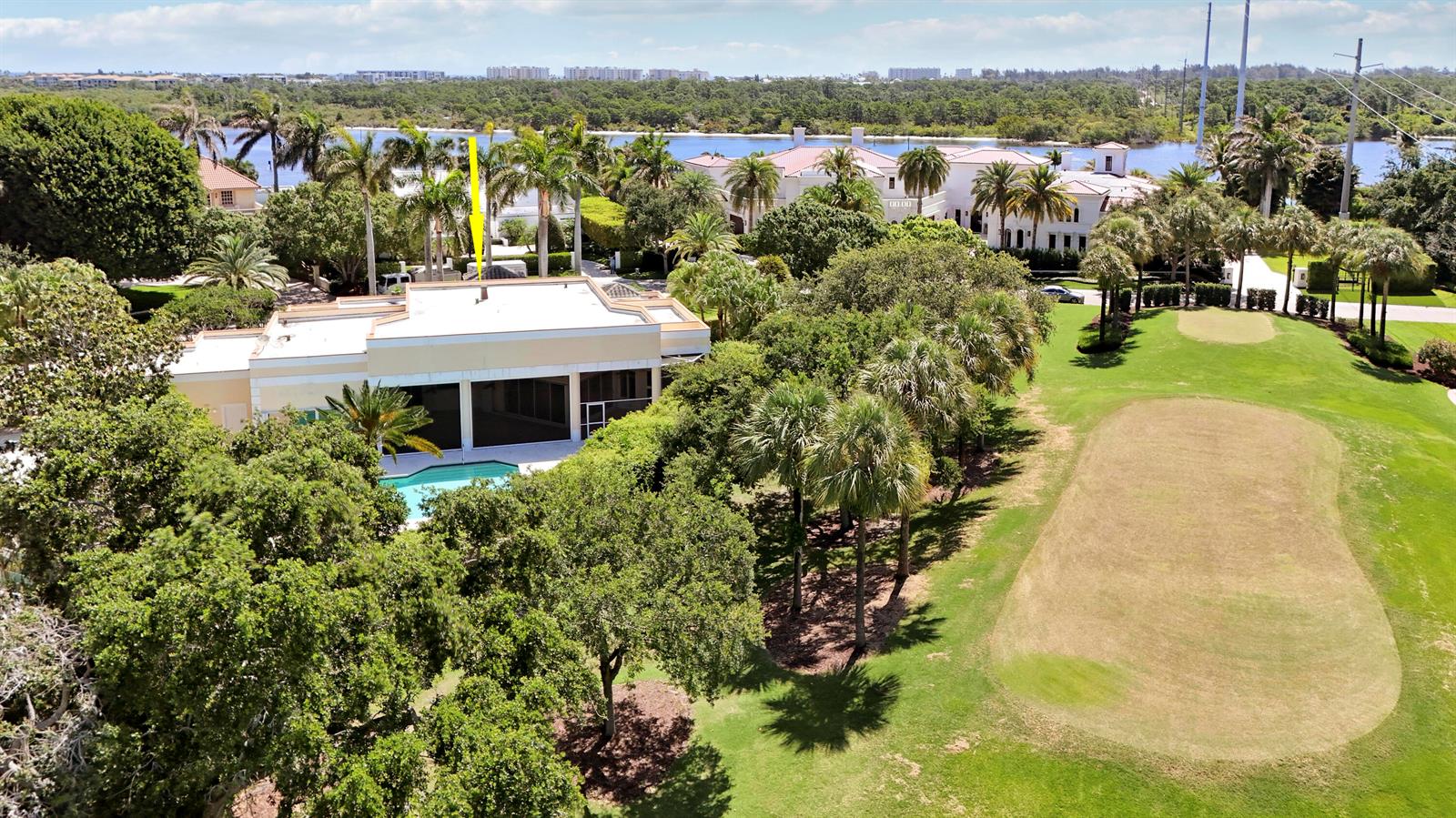 An aerial view shows a house with a flat roof, pool, and adjacent golf course — 171 Spyglass Lane, Jupiter FL 33477, JUPITER, FL