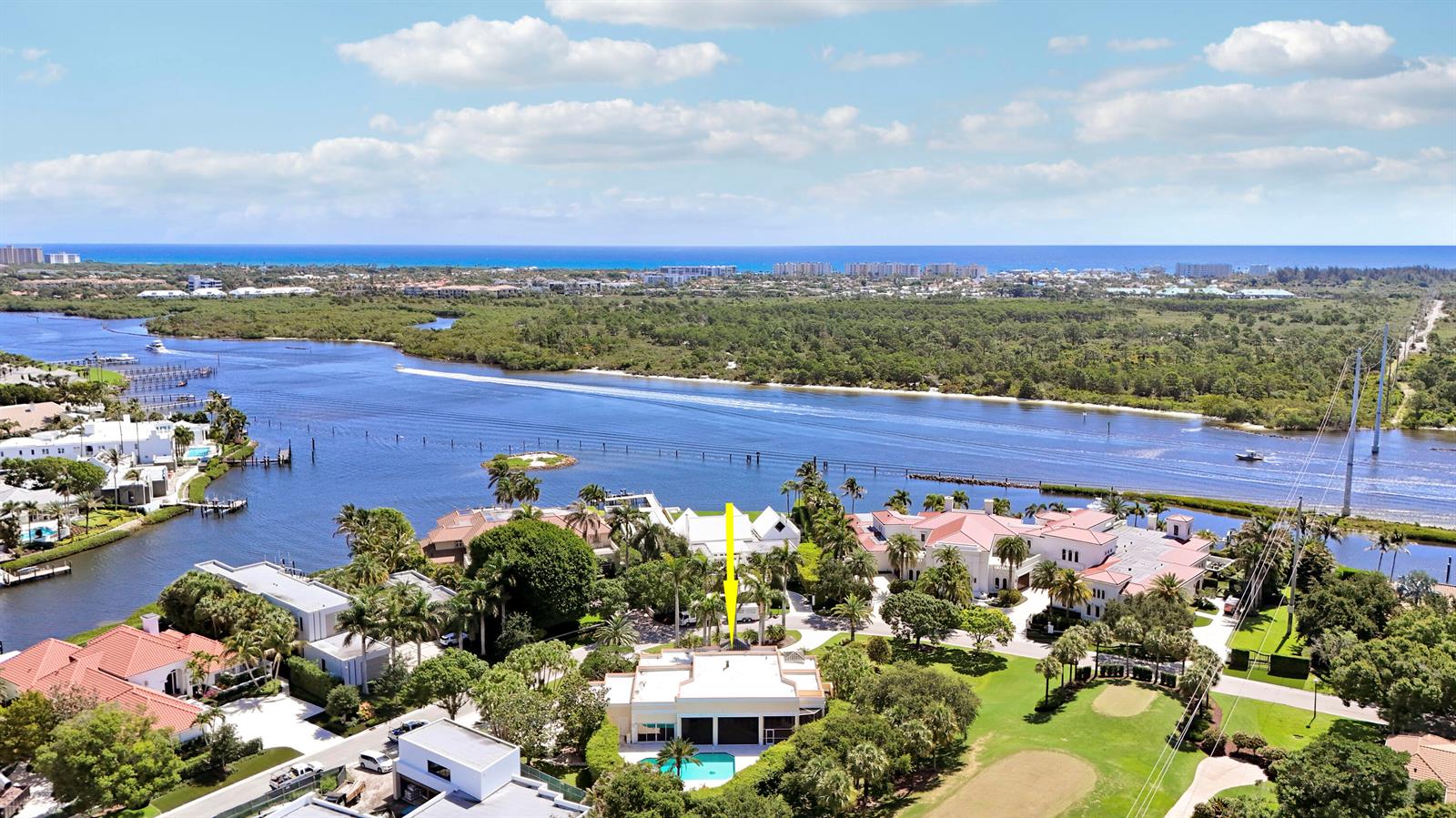 An aerial view shows a waterfront estate with a swimming pool and a yellow arrow — 171 Spyglass Lane, Jupiter FL 33477, JUPITER, FL