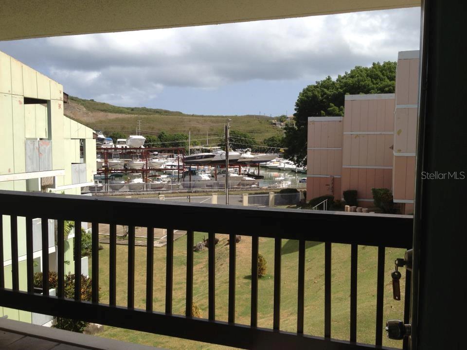 A view from a balcony overlooking a boat storage yard and a grassy area — Villa Marina Condo VILLA MARINA AVE. UNIT D201, FAJARDO, PR