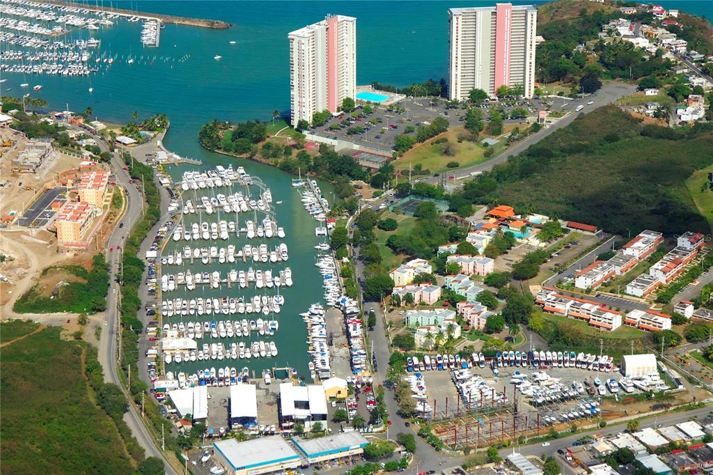 An aerial view shows a marina filled with boats next to residential buildings and coastlines — Villa Marina Condo VILLA MARINA AVE. UNIT D201, FAJARDO, PR