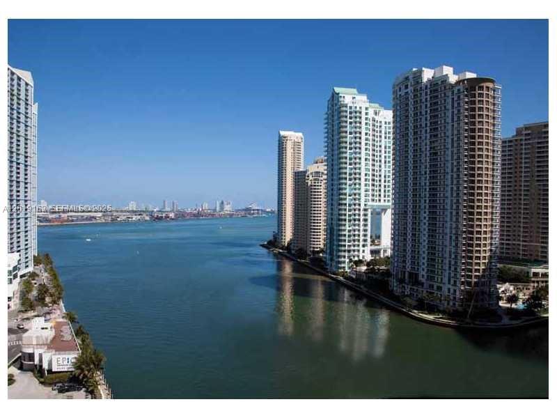 An elevated view of a waterfront city skyline featuring several tall residential high-rise buildings — 200 Biscayne Boulevard Way # 4904, Miami FL 33131, MIAMI, FL