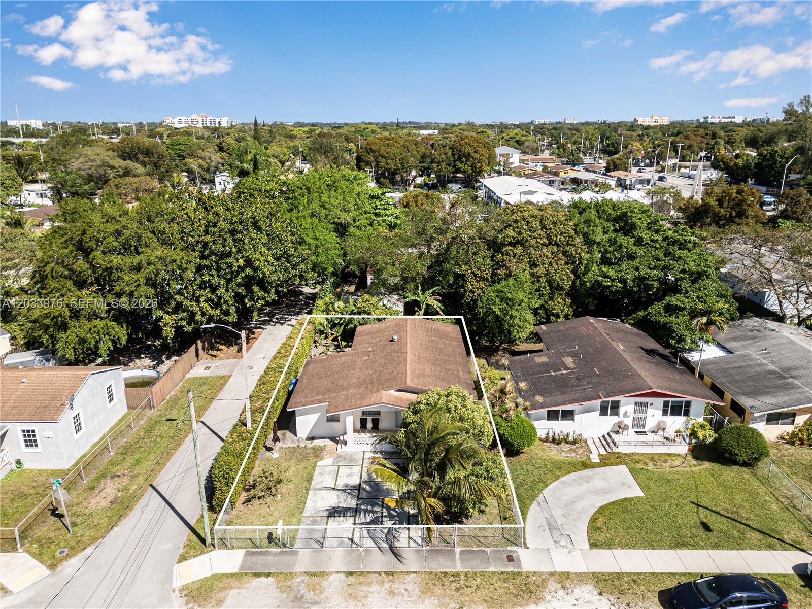 An aerial view shows a single-story house with a fenced yard and driveway — 1243 NW 42nd St, Miami FL 33142, MIAMI, FL