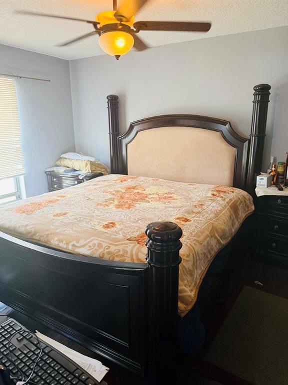 A bedroom features a large dark wood poster bed with a beige upholstered headboard — 2910 VIENNA LANE, KISSIMMEE, FL