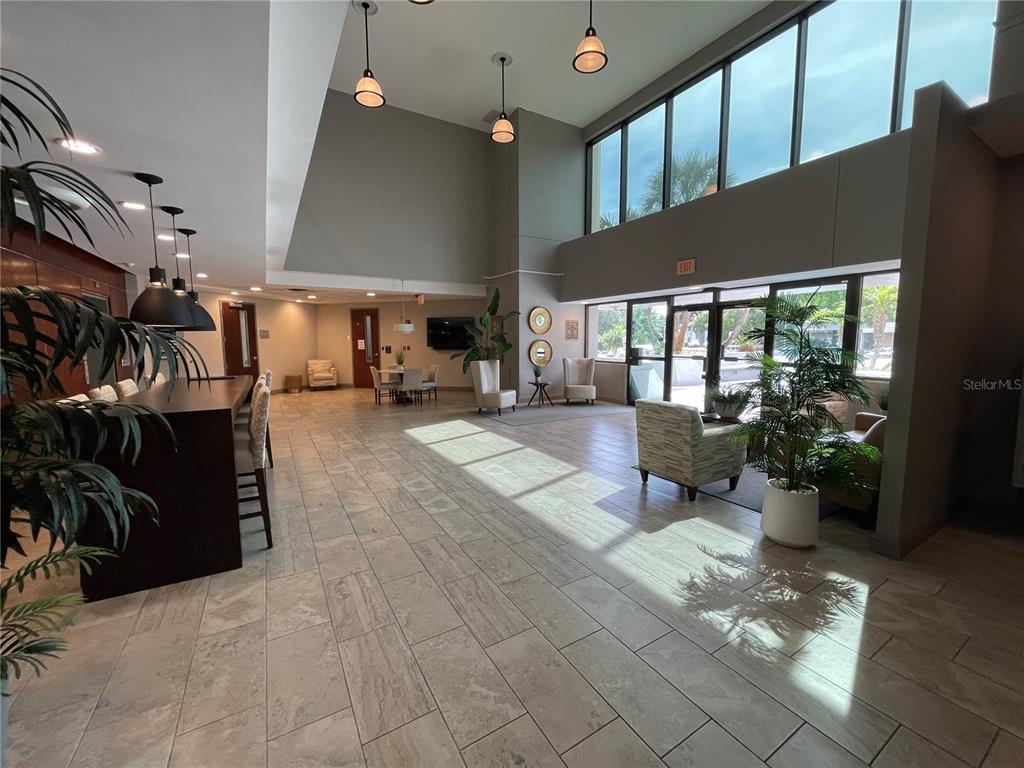 A spacious lobby features tile flooring, high ceilings with pendant lighting, and floor-to-ceiling windows — 1300 CITIZENS BOULEVARD, LEESBURG, FL