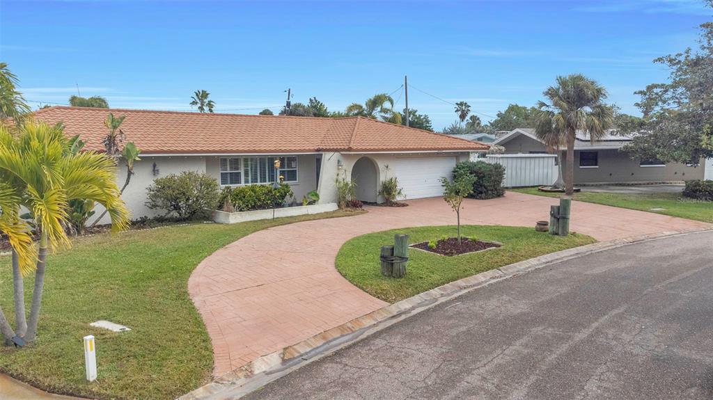 A single-story house with a terracotta tile roof and a curved paved driveway — 4313 50TH PLACE S, ST PETERSBURG, FL
