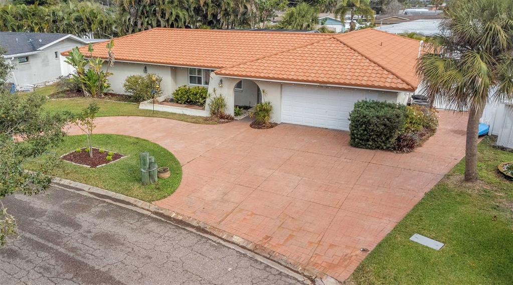 An exterior view of a single-story house with a tiled roof and a paved driveway — 4313 50TH PLACE S, ST PETERSBURG, FL