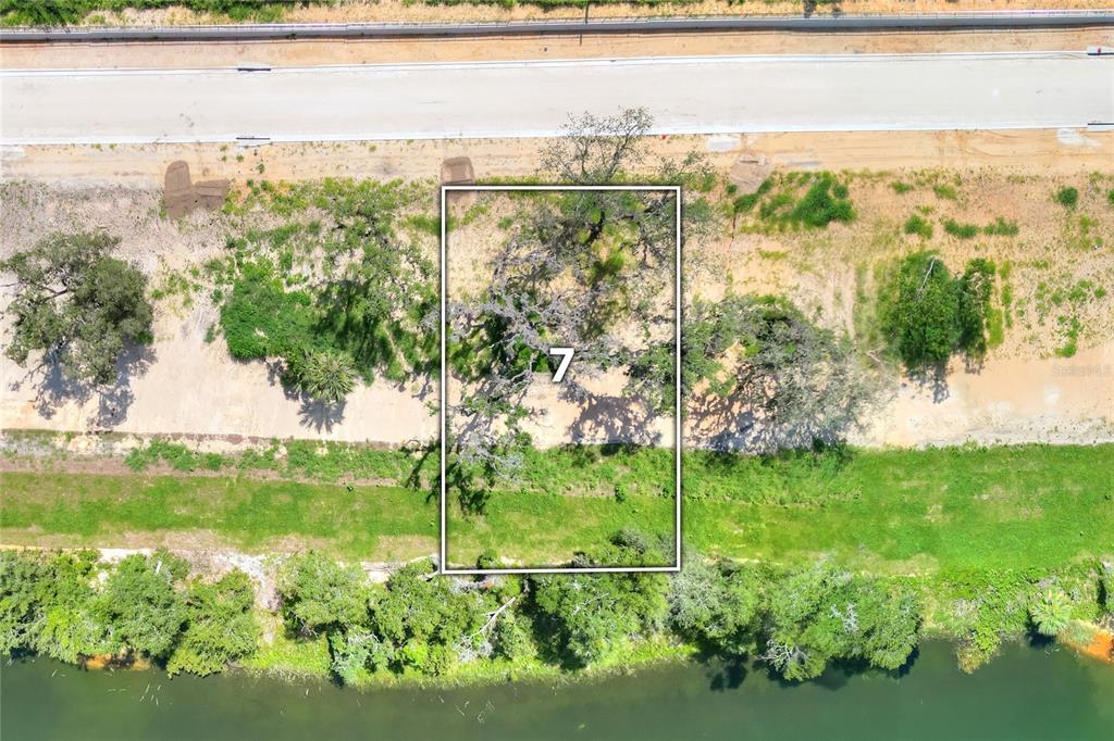 An aerial view shows a rectangular plot of land marked with the number seven — 169 TRANQUIL MIRROR LAKE COURT Lot 7, CLERMONT, FL