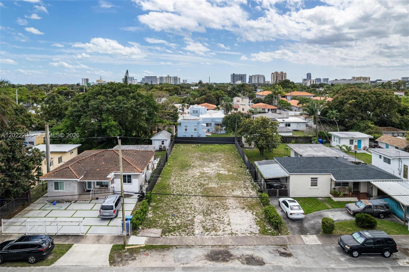 An aerial view shows a vacant rectangular lot situated between two single-story residential houses — 3056 SW 13th St, Miami FL 33145, MIAMI, FL