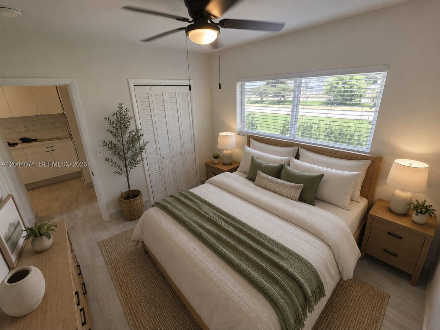 A bedroom features a queen bed, wooden nightstands, a ceiling fan, and a window view — 120 NE 10th Ave # 3, Hallandale Beach FL 33009, HALLANDALE BEACH, FL