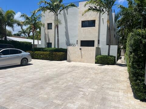 A modern two-story building with a paved driveway and palm trees in front — 1955 NE 4th Street Unit 2, Deerfield Beach FL 33441, DEERFIELD BEACH, FL