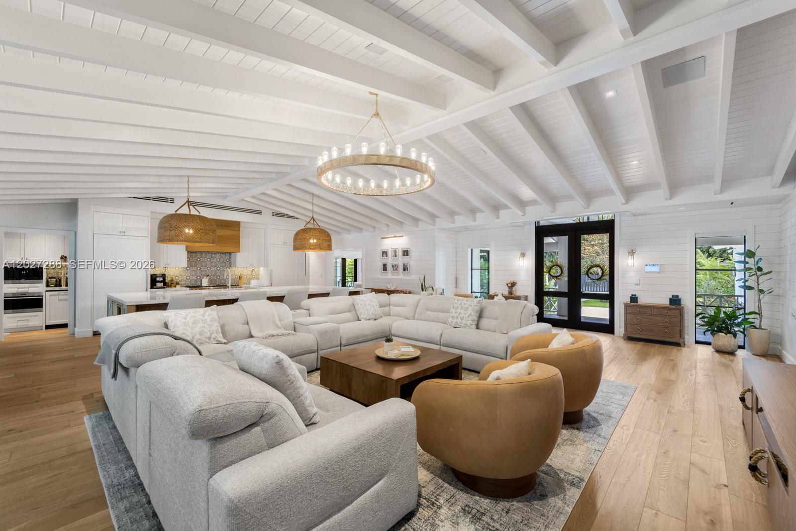 A spacious living room features a vaulted white ceiling, a large sectional, and two armchairs — 7101 SW 66th St, Miami FL 33143, MIAMI, FL