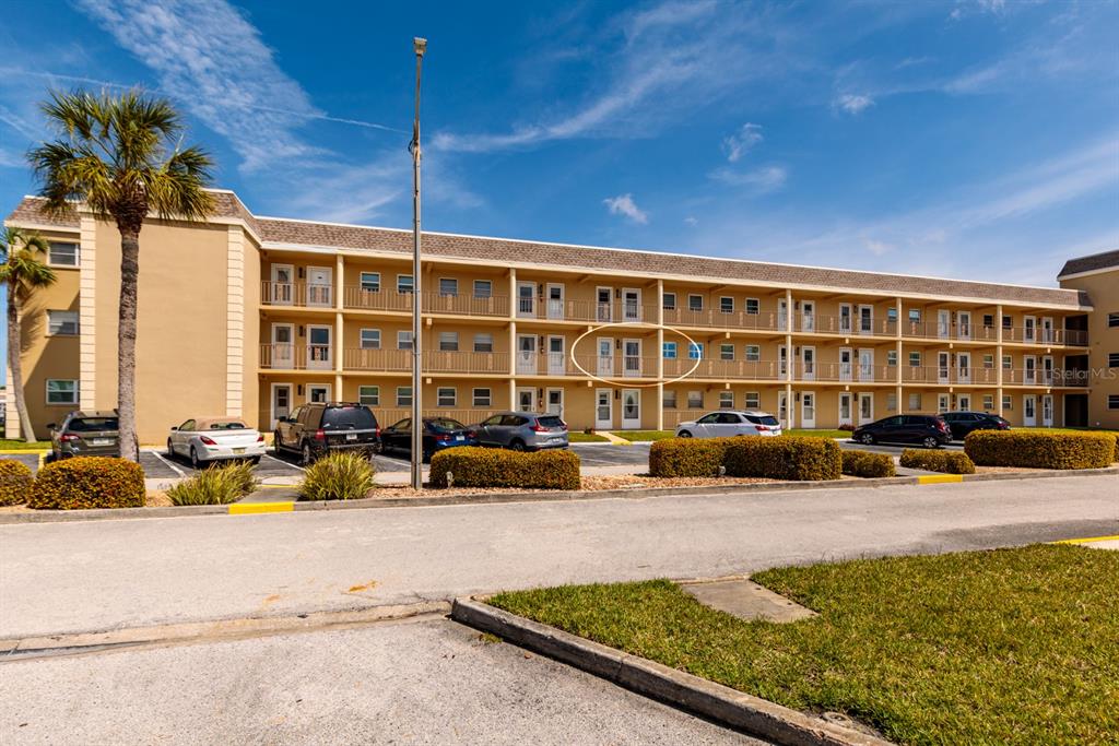 A multi-story apartment building exterior features a parking lot and a circled second-floor unit — 1 BOCA CIEGA POINT BOULEVARD UNIT 206, ST PETERSBURG, FL