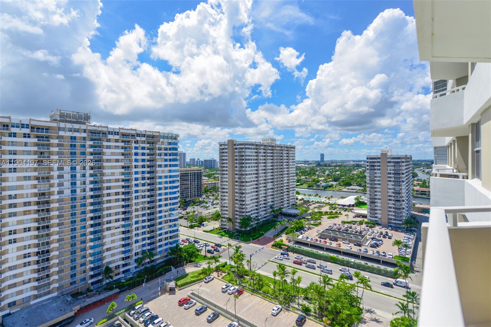 An elevated view shows several high-rise apartment buildings surrounded by parking lots and palm trees — 1950 S Ocean Dr # 19A, Hallandale Beach FL 33009, HALLANDALE BEACH, FL