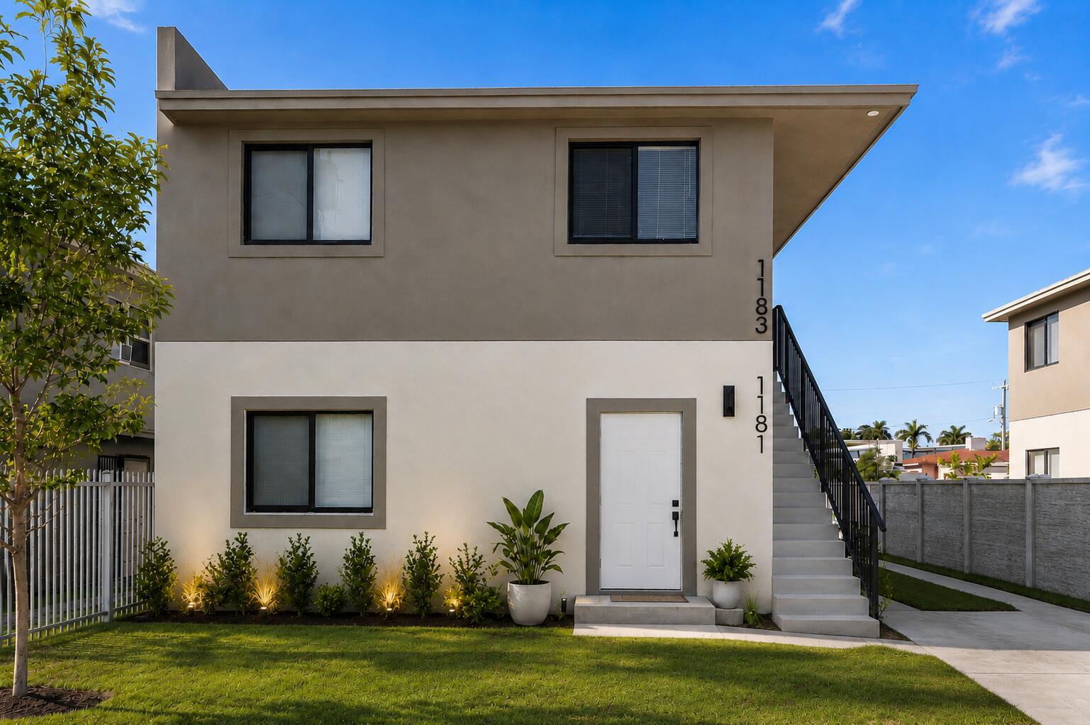 A two-story building exterior with a white lower level, grey upper level, and outdoor staircase — 1181 NW 66th Street # 1181, Miami FL 33150, MIAMI, FL