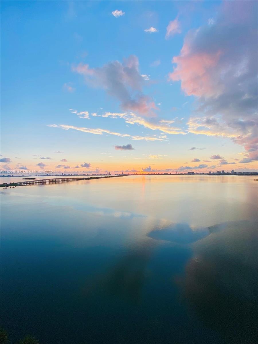 A wide view of a calm bay at sunset with a long bridge in the distance — 2900 NE 7th Ave # 1407, Miami FL 33137, MIAMI, FL